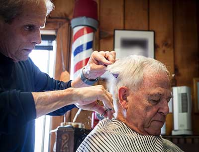 Image of barber cutting a mans hair