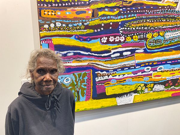 Winchanam woman Janet Koongotema with her painting ‘Waank Alk’, the story place of the dilly bag. Janet is an accomplished weaver who has turned her hand to painting
